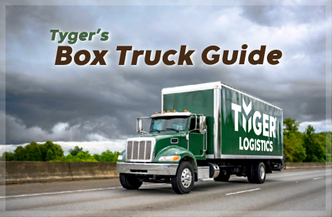 Tyger Times -Blogs and News -Tyger's Box Truck Guide - A green box truck with the white Tyger Logistics Logo on the side drives down the highway on a cloudy day with trees in the background.